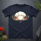 Navy blue t-shirt with a chef's hat and floral design on a dark surface.