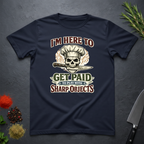 Navy blue t-shirt with skull and knife graphic and text "I'm Here to Get Paid the Play with Sharp objects" on a dark surface