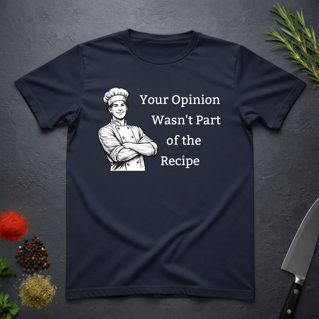 Navy blue t-shirt with a male chef graphic and text "Your Opinion Wasn't Part of the Recipe" on a dark surface with kitchen items.