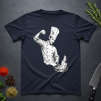 Nave Blue t-shirt with a artistic graphic of a chef sprinkling salt into a pan with fire on a dark surface with kitchen items.