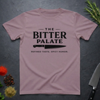 Paragon t-shirt with 'The Bitter Palate' logo on a dark surface with kitchen items.