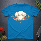 Sapphire Blue t-shirt with a chef's hat and floral design on a dark surface.