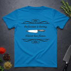 Sapphire Blue t-shirt with a knife graphic and text "Perfection is boring. Flavor has flaws." On a dark surface. 