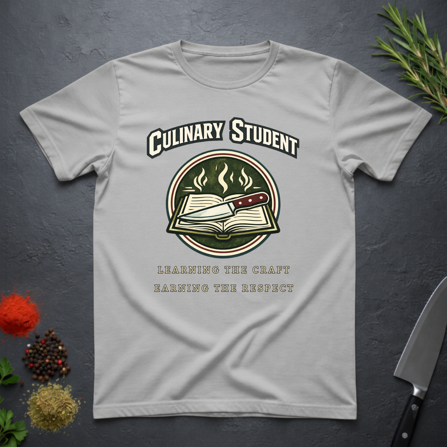 Sport Gray t-shirt with 'Culinary Student' graphic design on a dark surface with kitchen items.