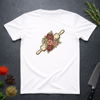 White t-shirt with a rolling pin and floral design on a dark surface.