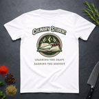 White t-shirt with 'Culinary Student' design on a dark surface with kitchen items.