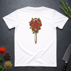 White t-shirt with a design of a whisk and roses as a bouquet on a dark surface.