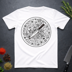 White t-shirt with a circular black and white floral design and knife on a dark surface.