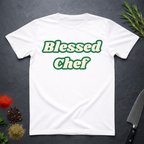 White t-shirt with 'Blessed Chef' text on a dark surface with kitchen items.