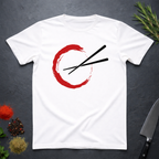 White t-shirt with red circle and black chopsticks design on a dark surface with kitchen items.
